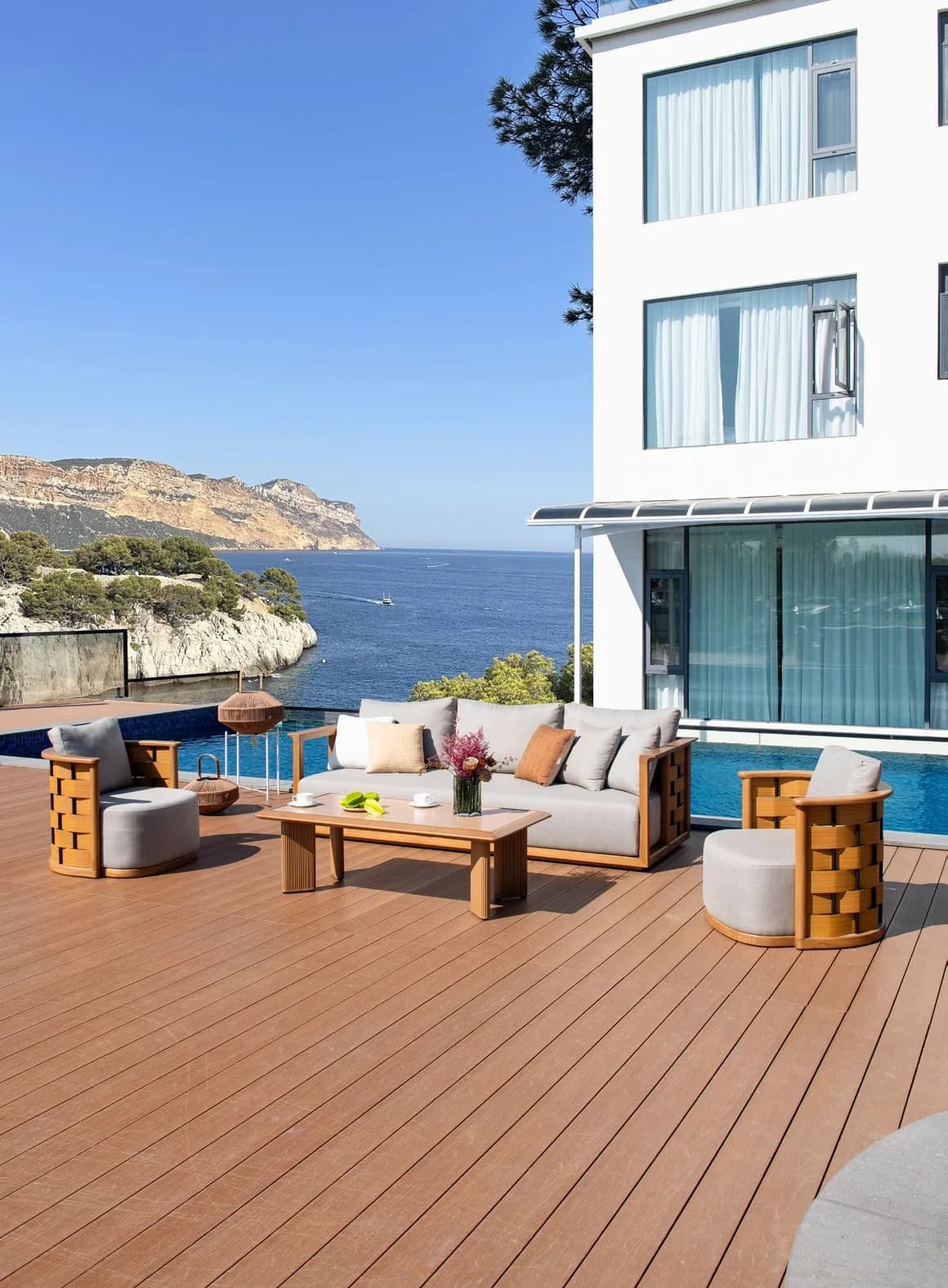 Timber outdoor lounge setting beside a pool