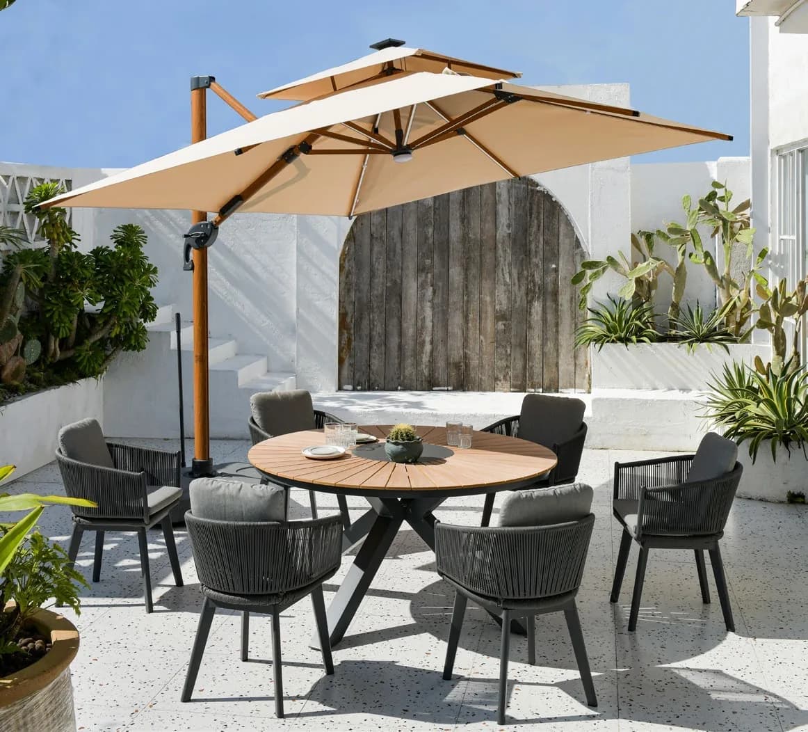 Outdoor dining set beneath a commercial parasol